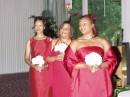 Each Bridesmaid and the Maid of Honor were allowed to choose a dress of their own taste in the Apple Red color better suited to her personality and figure.